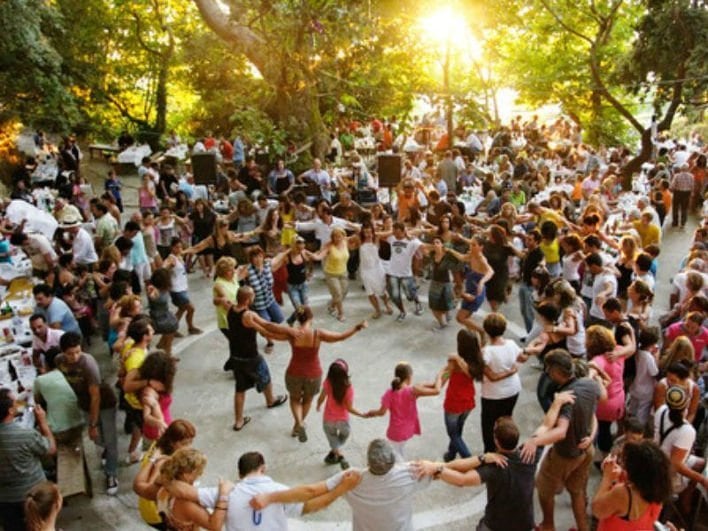 Flavors of August at Isioma Karies - Gastronomy Tours people dancing in circle at Flavors of August at Isioma Karies
