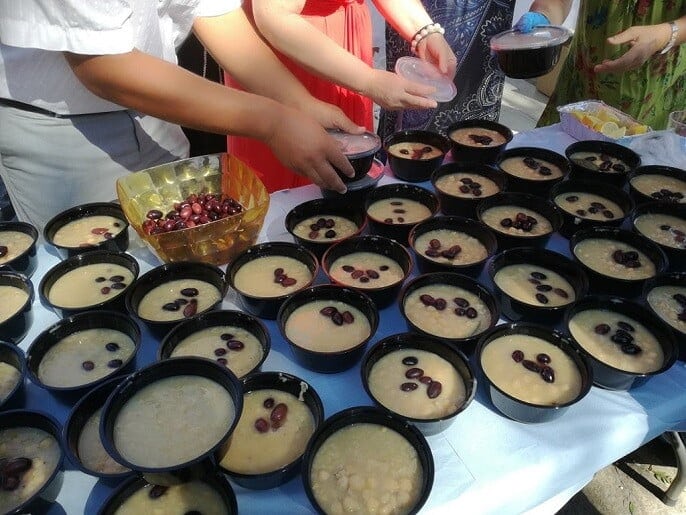 Festival for the Raising of the Holy Cross-Paros, Ageria - Gastronomy Tours women prepere bowls with 'revithada' soup at Festival for the Raising of the Holy Cross church, at Paros, Ageria, Greece