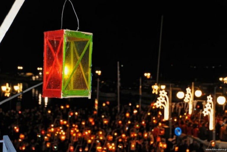 people front the church and holding illuminated lamps at The &ldquo;Fanarakia&rdquo; (lanterns) of Tinos, Greece by night