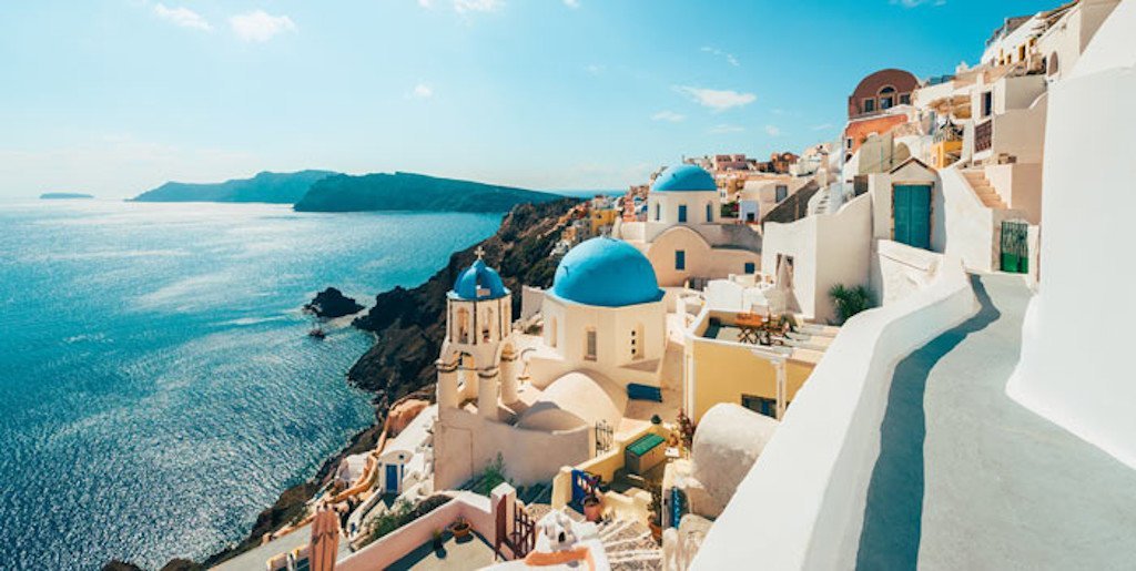 Top 10 dishes to try in Greece - Gastronomy Tours Top 10 dishes to try in Greece island with houses and the sea in the background||||||||||