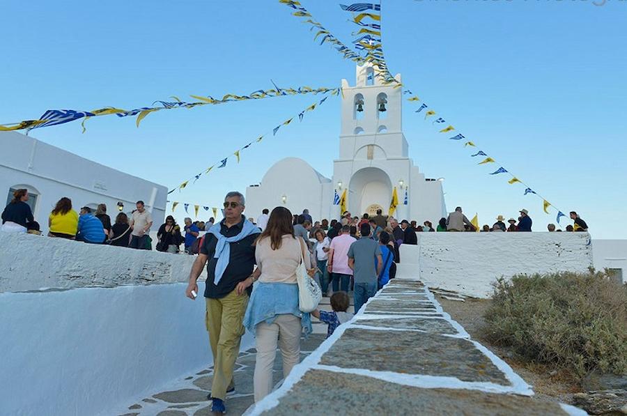 Sifnos, Festival of the Panagia of Chrisopigi - Gastronomy Tours people walking front the church of of Panagia of Chrisopigi - Gastronomy Tours