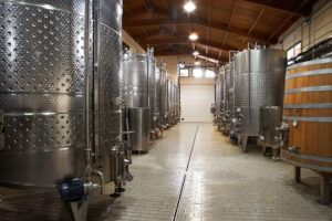 two rows of lying aluminum wine storage tanks at 'Wine Art Estate' plant