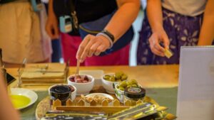 Close-up of tourists tasting olive oil and olives at Oilympian Koufolias