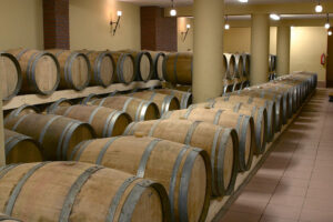 lying wine wood barrels on top of each other at illuminated 'Foundi Estate' cellar