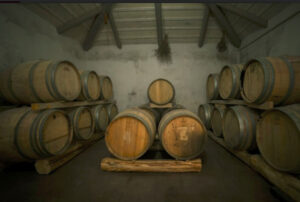 wine barrels on top of each other on the wood panels at Goumas Estate cellar