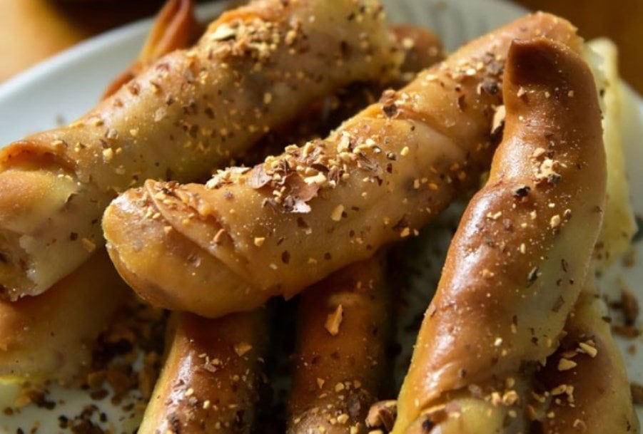 Katimeria - Gastronomy Tours close-up of Greek ‘Katimeria’ are fried pretzels of dough stuffed with fresh cheese