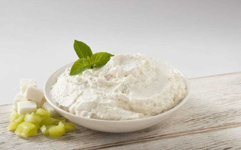 Ktipiti - Gastronomy Tours Close-up of bowl with Greek ‘Ktipiti’ a cheese-based spread and fresh green herbs on top