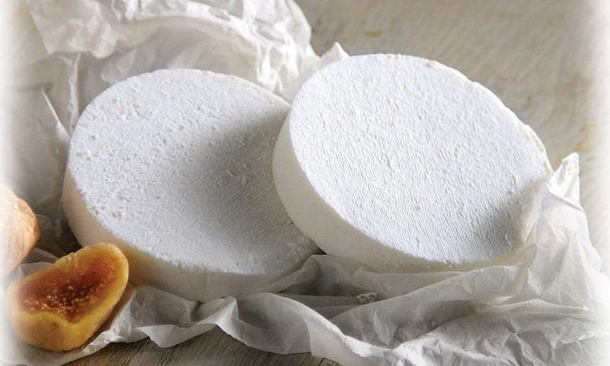 Manouri - Gastronomy Tours Close-up of round pieces of Greek ‘Manouri’ soft white table-cheese