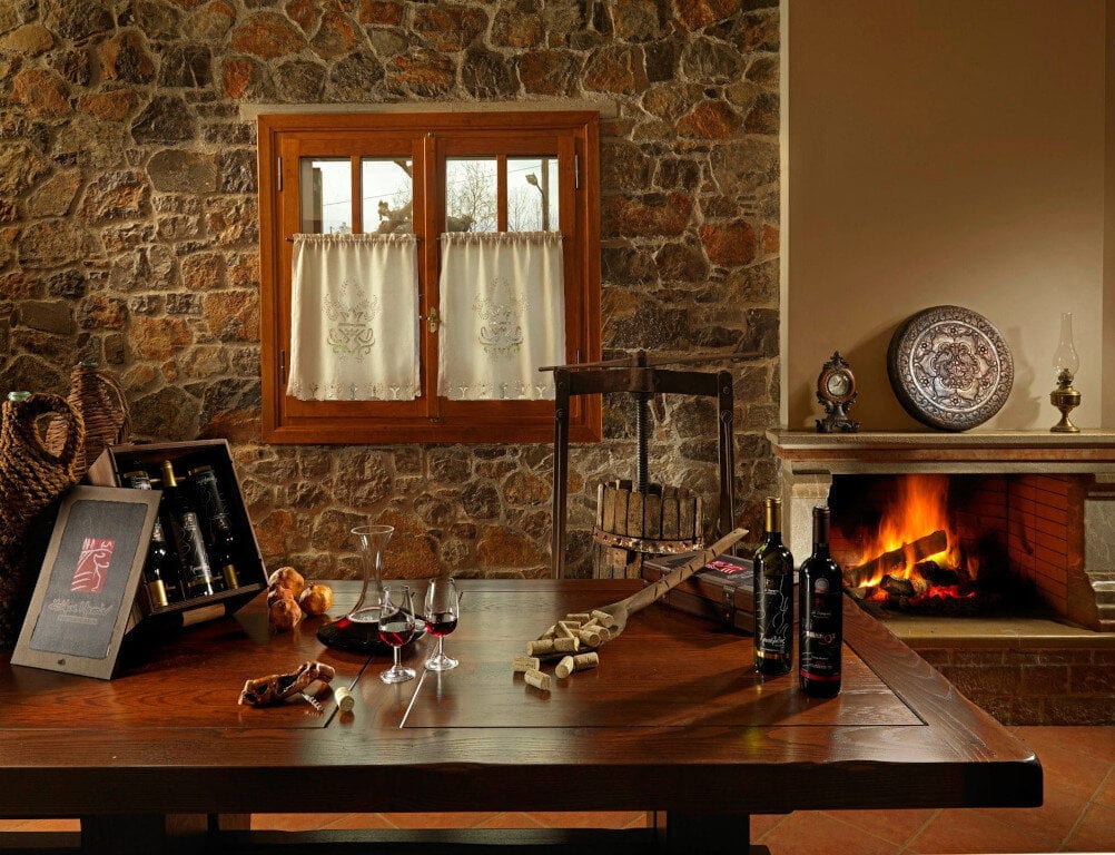 Muses Estate Awards - Gastronomy Tours bottle pf wine on the table at ‘Muses Estate’ room that recognized with many awards|