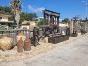 Old olive oil mill outside and amphora at Oilympian Koufolias