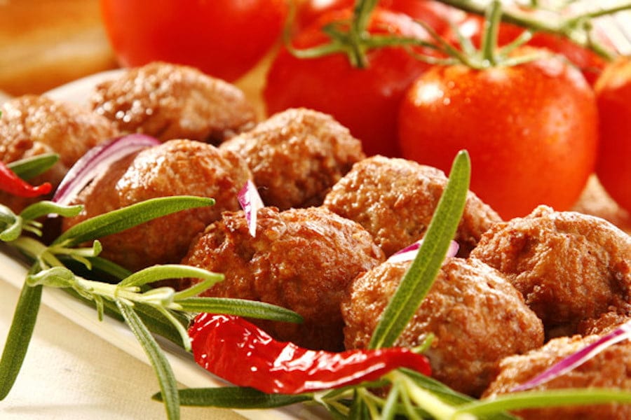 Pitaroudia - Gastronomy Tours Greek ‘pitaroudia’ are chickpea meatballs fried or even oven-baked and fresh tomatoes in the background