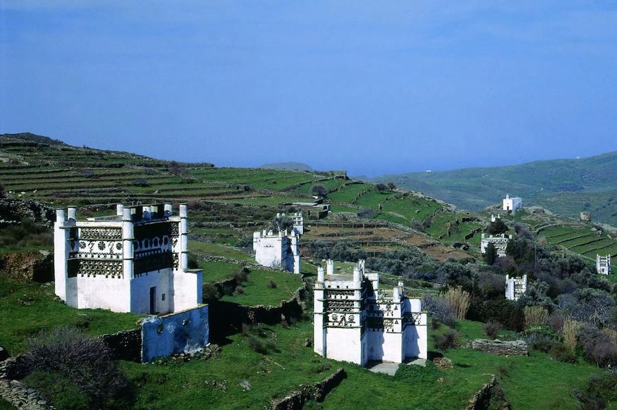 The Best Tinos food tours - Gastronomy Tours view of Tinos island pigeon houses and blue sky in the background
