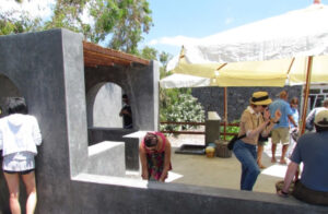 tourists crushing grapes by stepping barefoot on the grapes inside vats at 'Koutsoyannopoulos winery'