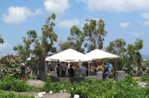 tourists crushing grapes by stepping barefoot on the grapes inside vats at 'Koutsoyannopoulos winery'