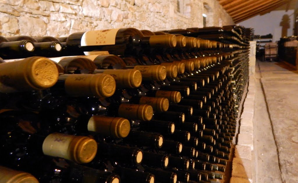Theotoky Estate Awards - Gastronomy Tours wine bottles storage on shelves on top of each other at ‘Theotoky Estate’ cellar that recognized with many awards|