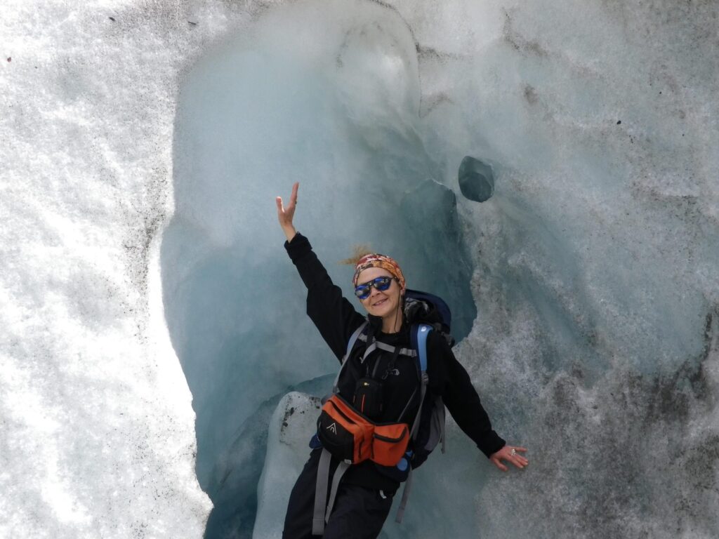 a woman climber smiling at the camera