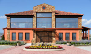 Alpha Estate entrance outside with stone pavement and flowers in the front
