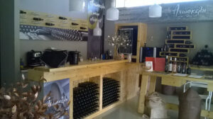 'Anoskeli' tasting room with stacked bottles in the storage locker