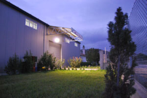 illuminated building at 'Belidis Vineyards' by night with lawn grass in the front