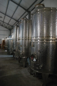 lying aluminum wine storage tanks at 'Belidis Vineyards' plant