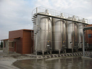 lying outside aluminum wine storage tanks at 'Evritika Kellaria' facilities