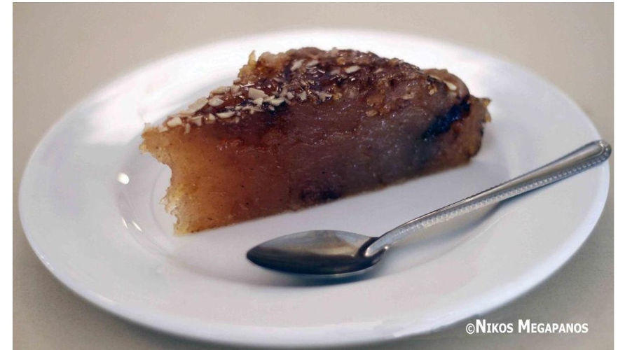 Halva Farsalon - Gastronomy Tours Close-up of plate with a piece of Greek ‘Halva Farsalon’ means pan-baked sweet covered with syrup and a sweet spoon