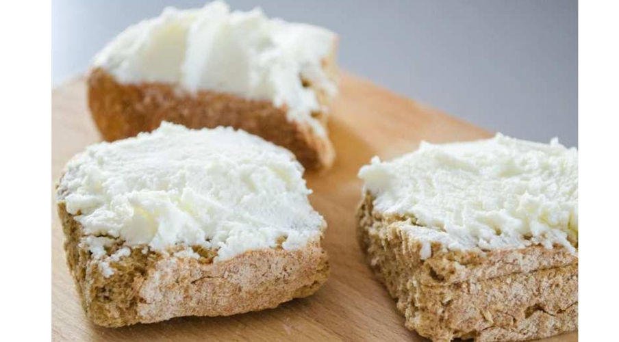 Katiki - Gastronomy Tours close-up of Greek ‘Katiki’ means a fresh and light soft white cheese spreading on three slices of dry bread