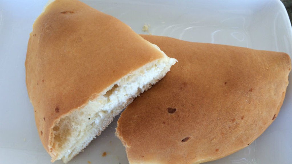 Koukoulopita - Gastronomy Tours close-up of half of Greek ‘koukoulopita’ is filled with white cheese