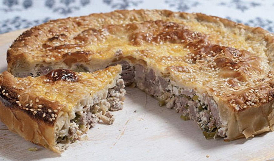 Kreatotourta - Gastronomy Tours Close-up of pieces of Greek ‘Kreatotourta’ means pie with mixture of lamb and chees baked in oven