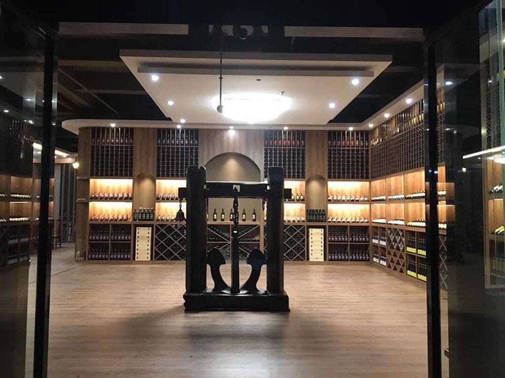 Lykos Winery Awards - Gastronomy Tours old press of grapes at ‘Lykos Winery’ cellar that recognized with many awards||logo Lykos winery company