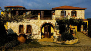 'Marianna' stone building with arcade entrance and windows and green lawn in the front
