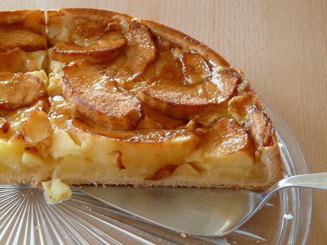 Pita - Gastronomy Tours piece of Greek milopita, pita using pastry crust or filo baked in the oven filling with cream and apples on top