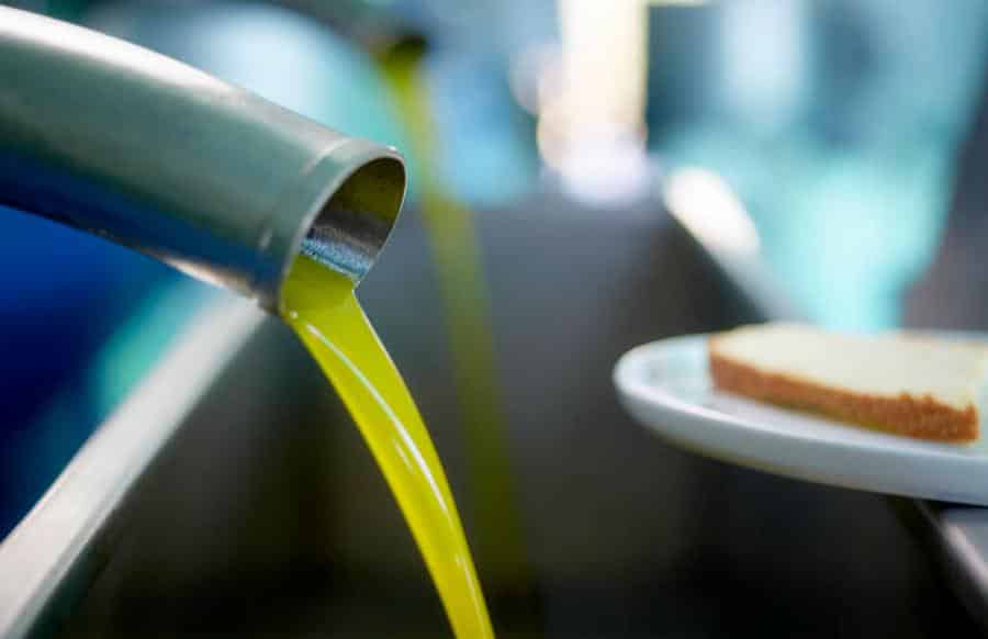 Melas Epidauros Olive Oil Domain Awards - Gastronomy Tours close-up of olive oil flowed from pump at Melas Epidauros Olive Oil Domain|Melas Epidauros Olive Oil Domain logo
