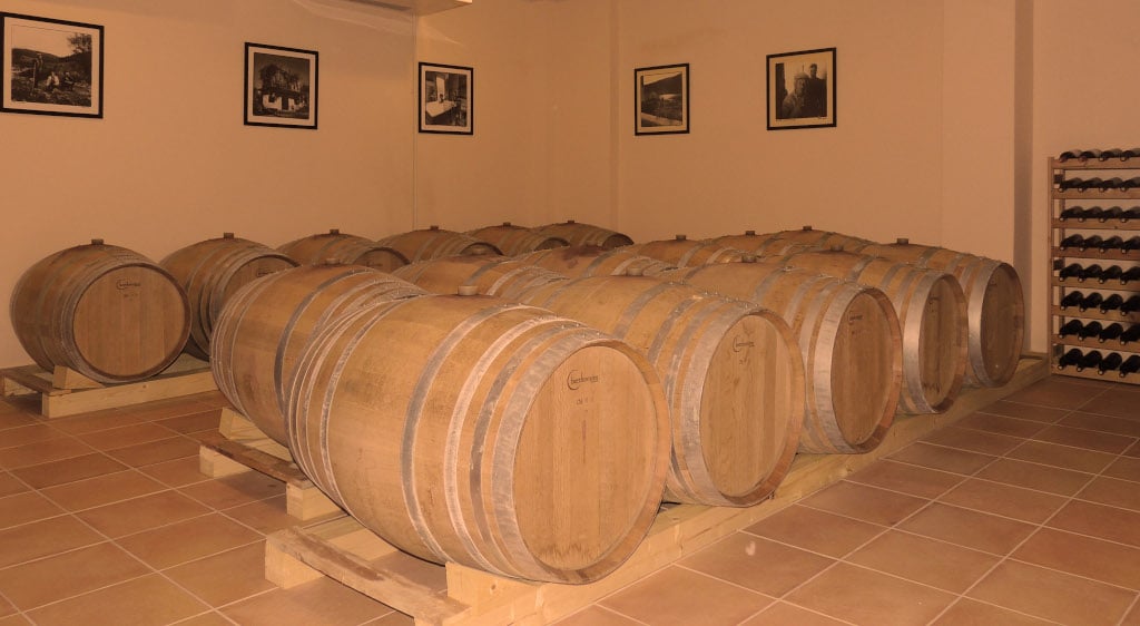 Olympia Land Estate Awards - Gastronomy Tours lying wooden barrels in a row at ‘Olympia Land Estate’ cellar that recognized with many awards|