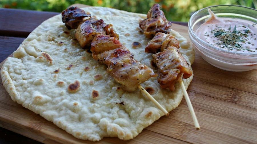 Pita - Gastronomy Tours pita with souvlaki on wooden surface