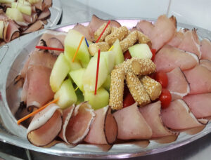 plateau with louza, tomato cherries, melon,breadsticks and colourful toothpicks at 'Roussounelos Meat Market'
