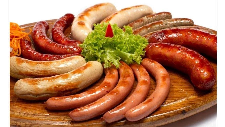 Sausage - Gastronomy Tours Grilled various sausages made from ground pork or beef with spices putting in circle and green fresh salad in center