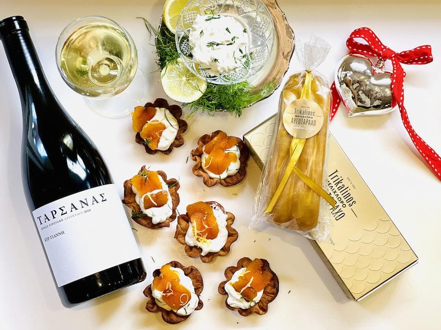 Newsletter - December 2022 - Gastronomy Tours Mini tart with yogurt cream, grey mullet bottarga slices and a bottle of wine