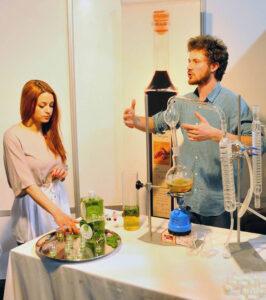 girl listening to a man giving a tour at 'Tentoura Castro Distillery' laboratory