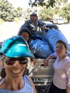 two couples near a car loaded with acorns smiling happily at the camera at Oakmel