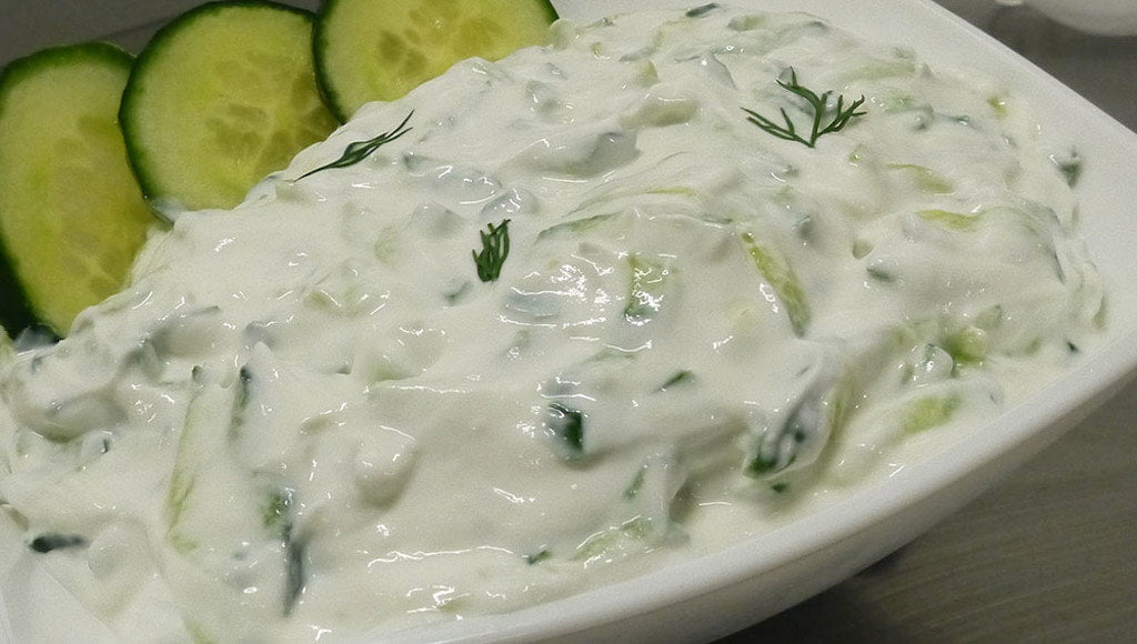 Tzatziki - Gastronomy Tours Close-up of Greek ‘Tzatziki’ means yogurt with pieces of cucumber