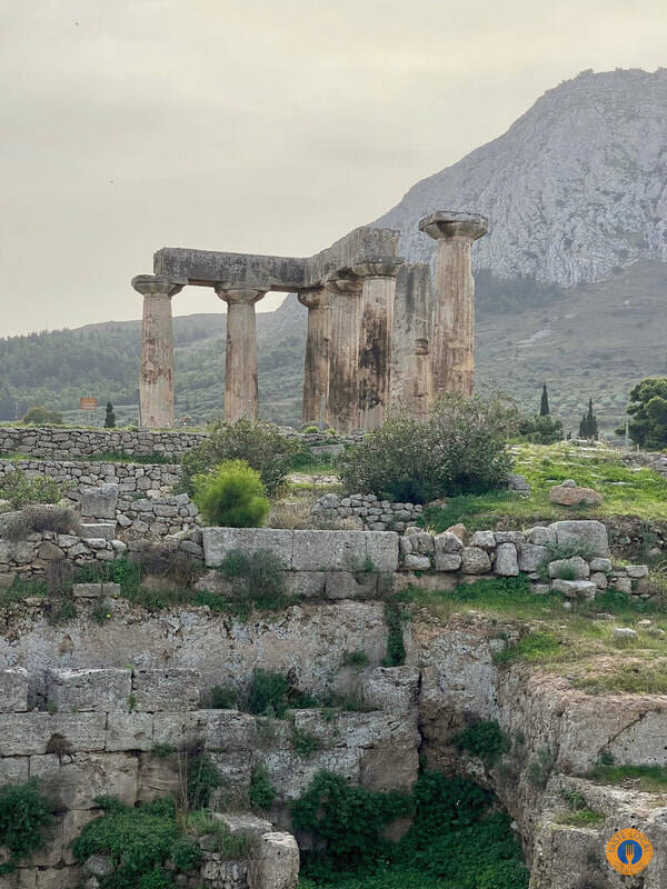 Akrocorinthos, the biggest ancient fortress of the Peloponnese. - Gastronomy Tours a stone ruins with a mountain in the background in Akrocorinthos