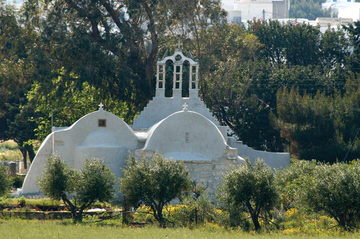 The Festival of Pera Panagia, Paros, Marmara - Gastronomy Tours White chapel surrounded by greenery