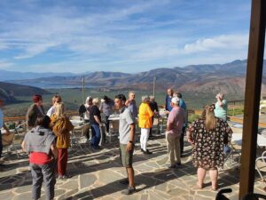 S8khVP0b_visitors listening to a guide and mountains and olive groves in the background-Gastronomy Tours.jpg