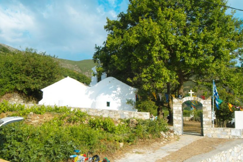 The Festival of Saints Constantine and Helen in Komiaki, Naxos - Gastronomy Tours White church surrounded by greenery.