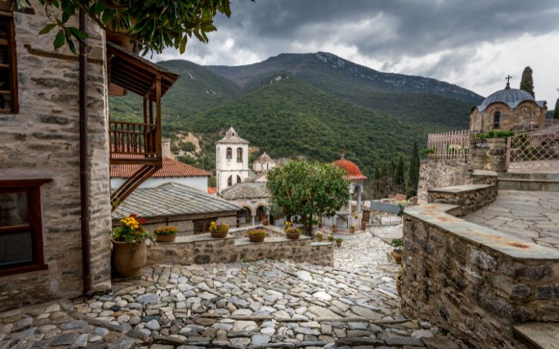 Serres food tours - Gastronomy Tours a stone walkway with a stone building and trees in the background